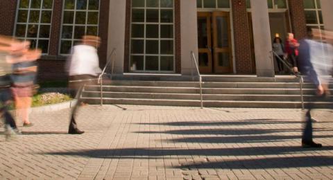 UNH students walking in front of building